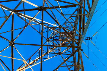 the power transmission tower against the blue sky