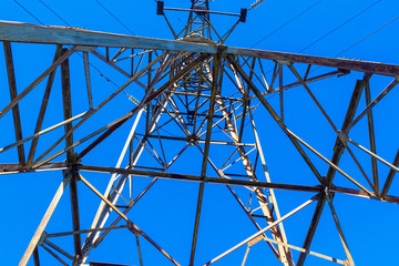 the power transmission tower against the blue sky