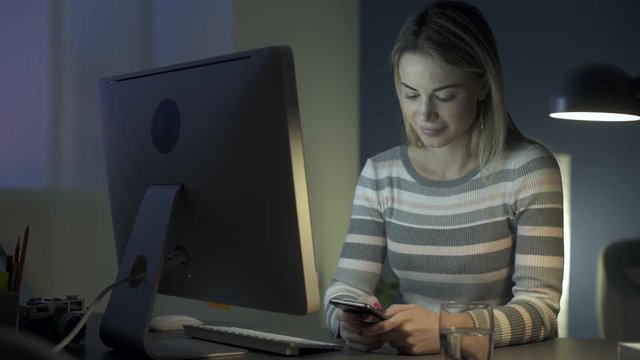 Woman chatting with her phone late at night