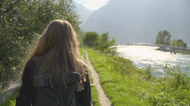 Teenage Girl Walking Along hte River