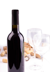 The Red wine glasses, bottle and corks. Isolated on white background