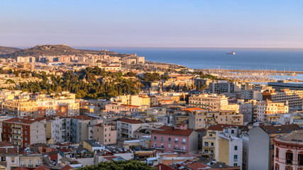 Fototapeta premium Cagliary, capital of Sardinia (Sardegna), Italy. Aerial panoramic view of the city. Cityscape at golden hours.