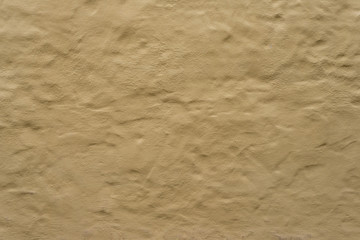 Fototapeta na wymiar Rough bumpy brown yellow concrete plaster stucco texture or surface background.
