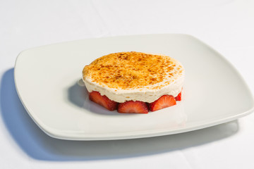 Strawberry dessert served with caramelized vanilla cream
