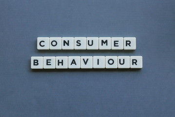 ' Consumer Behaviour ' word made of square letter word on grey background.