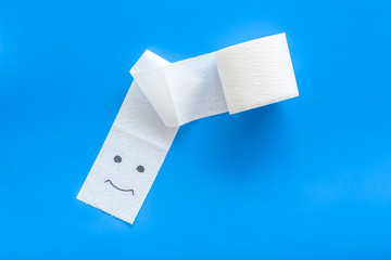 Toilet paper roll on blue background top view