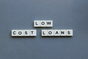 ' Low Cost Loans ' word made of square letter word on grey background.