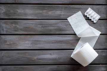 Disease of colon concept with toilet paper roll and rectal suppository on wooden background top view mockup