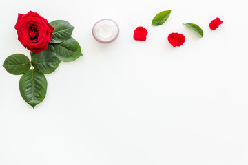 Natural floral cosmetics with rose flowers for face and body care on white background top view mock up