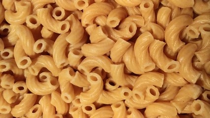 Dry elbow macaroni Italian pasta closeup cooked