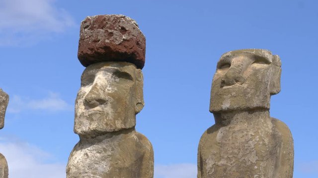 CLOSE UP Detailed shot of mysterious monolithic structures shaped as humans. Spectacular shot of world famous moais in Rapa Nui on a sunny summer day. Legendary archaeological finding on Easter Island