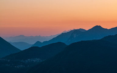 Fototapeta na wymiar Mountains rising over the Lago di Como lake in the evening