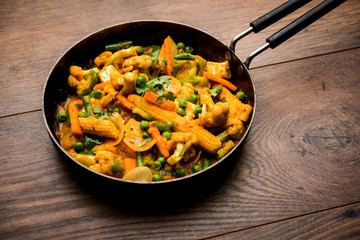Mix vegetable curry - Indian main course recipe contains Carrots, cauliflower, green peas and beans, baby corn, capsicum and paneer/cottage cheese with traditional masala and curry, selective focus