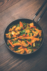 Mix vegetable curry - Indian main course recipe contains Carrots, cauliflower, green peas and beans, baby corn, capsicum and paneer/cottage cheese with traditional masala and curry, selective focus