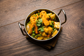 Mix vegetable curry - Indian main course recipe contains Carrots, cauliflower, green peas and beans, baby corn, capsicum and paneer/cottage cheese with traditional masala and curry, selective focus
