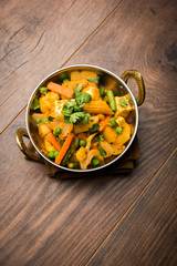 Mix vegetable curry - Indian main course recipe contains Carrots, cauliflower, green peas and beans, baby corn, capsicum and paneer/cottage cheese with traditional masala and curry, selective focus