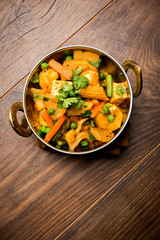 Mix vegetable curry - Indian main course recipe contains Carrots, cauliflower, green peas and beans, baby corn, capsicum and paneer/cottage cheese with traditional masala and curry, selective focus