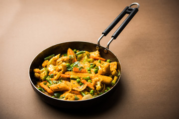 Mix vegetable curry - Indian main course recipe contains Carrots, cauliflower, green peas and beans, baby corn, capsicum and paneer/cottage cheese with traditional masala and curry, selective focus