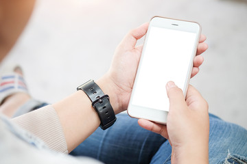 Cropped shot view of man hands holding smart phone with blank copy space screen for your text message or information content, female reading text message on cell telephone during in urban setting. 