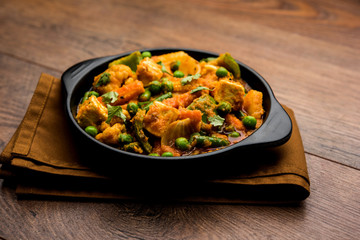 Mix vegetable curry - Indian main course recipe contains Carrots, cauliflower, green peas and beans, baby corn, capsicum and paneer/cottage cheese with traditional masala and curry, selective focus