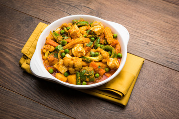 Mix vegetable curry - Indian main course recipe contains Carrots, cauliflower, green peas and beans, baby corn, capsicum and paneer/cottage cheese with traditional masala and curry, selective focus