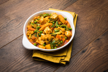 Mix vegetable curry - Indian main course recipe contains Carrots, cauliflower, green peas and beans, baby corn, capsicum and paneer/cottage cheese with traditional masala and curry, selective focus