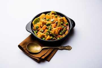 Mix vegetable curry - Indian main course recipe contains Carrots, cauliflower, green peas and beans, baby corn, capsicum and paneer/cottage cheese with traditional masala and curry, selective focus