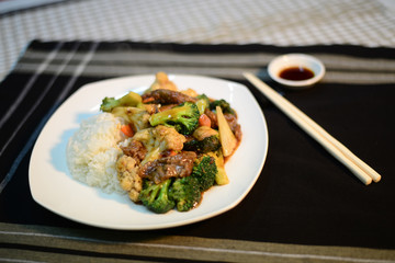 Chinese cuisine, Beef and vegetables on rice, set up nicely on a table ready to serve