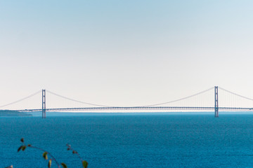The Mighty Mackinac Bridge towering over Lake Michigan on a clear summer day