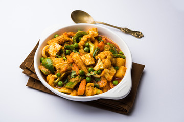 Mix vegetable curry - Indian main course recipe contains Carrots, cauliflower, green peas and beans, baby corn, capsicum and paneer/cottage cheese with traditional masala and curry, selective focus