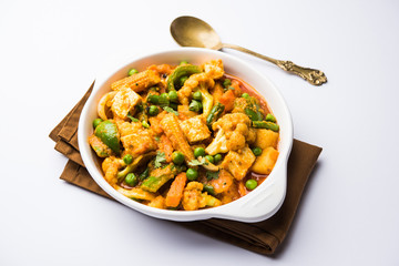Mix vegetable curry - Indian main course recipe contains Carrots, cauliflower, green peas and beans, baby corn, capsicum and paneer/cottage cheese with traditional masala and curry, selective focus