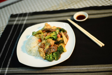 Chinese cuisine, Beef and vegetables on rice, set up nicely on a table ready to serve