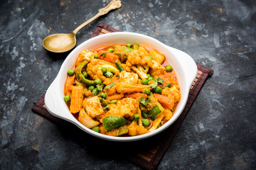 Mix vegetable curry - Indian main course recipe contains Carrots, cauliflower, green peas and beans, baby corn, capsicum and paneer/cottage cheese with traditional masala and curry, selective focus