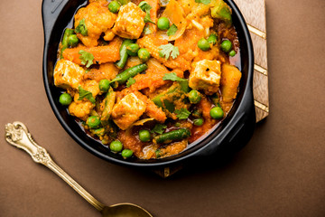 Mix vegetable curry - Indian main course recipe contains Carrots, cauliflower, green peas and beans, baby corn, capsicum and paneer/cottage cheese with traditional masala and curry, selective focus