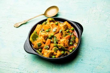 Mix vegetable curry - Indian main course recipe contains Carrots, cauliflower, green peas and beans, baby corn, capsicum and paneer/cottage cheese with traditional masala and curry, selective focus