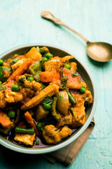 Mix vegetable curry - Indian main course recipe contains Carrots, cauliflower, green peas and beans, baby corn, capsicum and paneer/cottage cheese with traditional masala and curry, selective focus