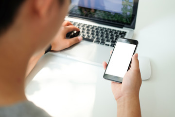Cropped shot view of man hands holding smart phone with blank copy space screen for your text message or information content, female reading text message on cell telephone during in urban setting.