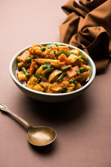 Mix vegetable curry - Indian main course recipe contains Carrots, cauliflower, green peas and beans, baby corn, capsicum and paneer/cottage cheese with traditional masala and curry, selective focus