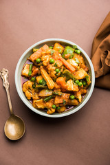 Mix vegetable curry - Indian main course recipe contains Carrots, cauliflower, green peas and beans, baby corn, capsicum and paneer/cottage cheese with traditional masala and curry, selective focus