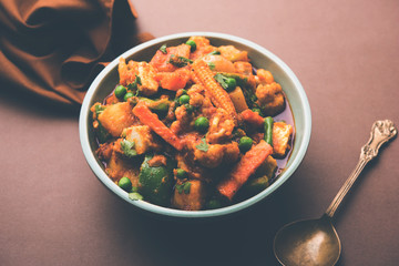 Mix vegetable curry - Indian main course recipe contains Carrots, cauliflower, green peas and beans, baby corn, capsicum and paneer/cottage cheese with traditional masala and curry, selective focus