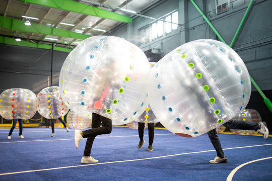 Young friends playing with bumper balls