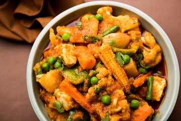 Mix vegetable curry - Indian main course recipe contains Carrots, cauliflower, green peas and beans, baby corn, capsicum and paneer/cottage cheese with traditional masala and curry, selective focus