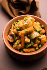Mix vegetable curry - Indian main course recipe contains Carrots, cauliflower, green peas and beans, baby corn, capsicum and paneer/cottage cheese with traditional masala and curry, selective focus