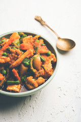 Mix vegetable curry - Indian main course recipe contains Carrots, cauliflower, green peas and beans, baby corn, capsicum and paneer/cottage cheese with traditional masala and curry, selective focus