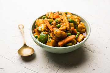 Mix vegetable curry - Indian main course recipe contains Carrots, cauliflower, green peas and beans, baby corn, capsicum and paneer/cottage cheese with traditional masala and curry, selective focus