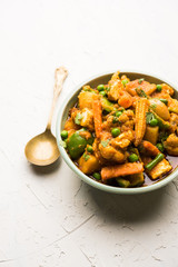 Mix vegetable curry - Indian main course recipe contains Carrots, cauliflower, green peas and beans, baby corn, capsicum and paneer/cottage cheese with traditional masala and curry, selective focus