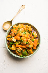 Mix vegetable curry - Indian main course recipe contains Carrots, cauliflower, green peas and beans, baby corn, capsicum and paneer/cottage cheese with traditional masala and curry, selective focus