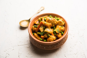 Mix vegetable curry - Indian main course recipe contains Carrots, cauliflower, green peas and beans, baby corn, capsicum and paneer/cottage cheese with traditional masala and curry, selective focus