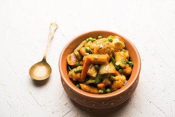 Mix vegetable curry - Indian main course recipe contains Carrots, cauliflower, green peas and beans, baby corn, capsicum and paneer/cottage cheese with traditional masala and curry, selective focus