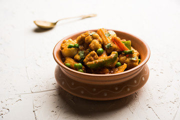 Mix vegetable curry - Indian main course recipe contains Carrots, cauliflower, green peas and beans, baby corn, capsicum and paneer/cottage cheese with traditional masala and curry, selective focus